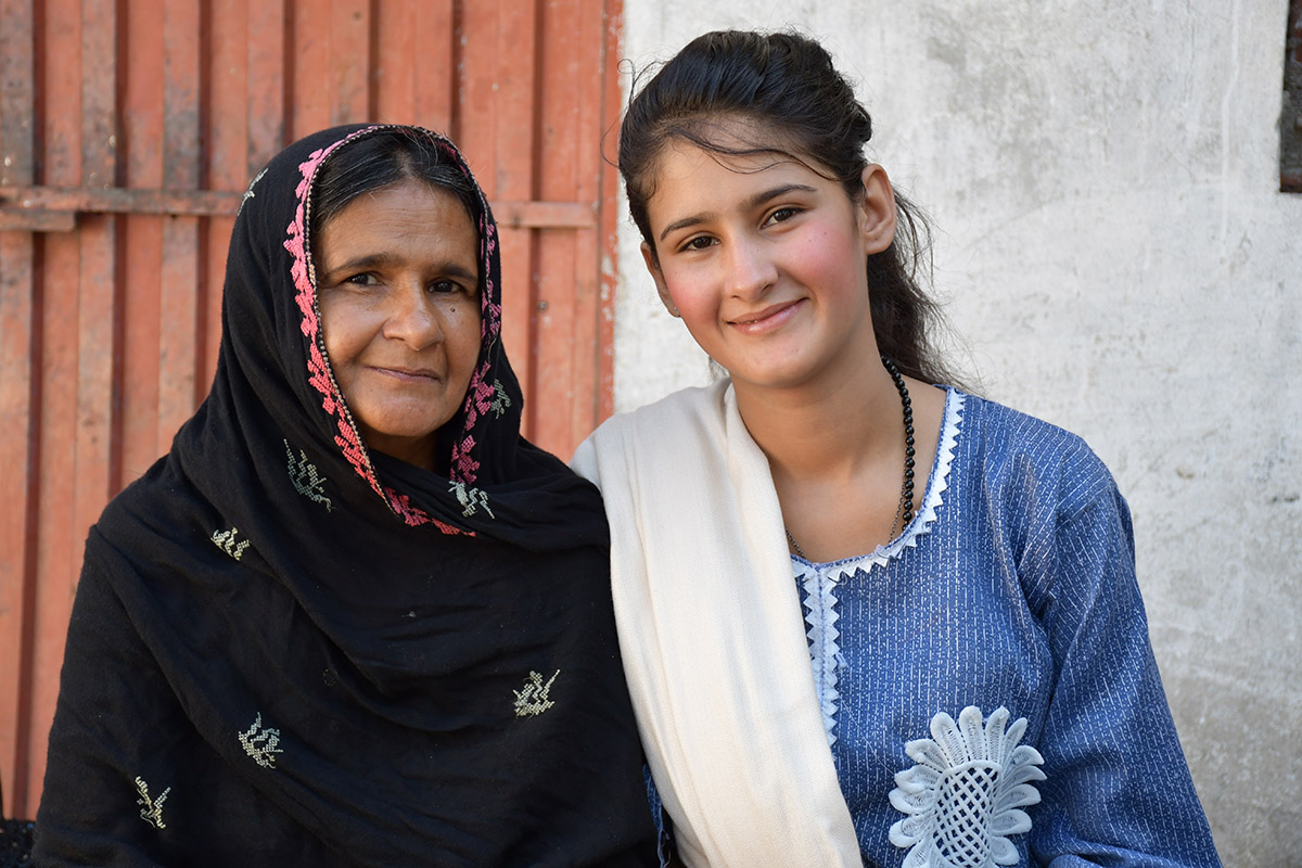 Dua and her mother outside their home.